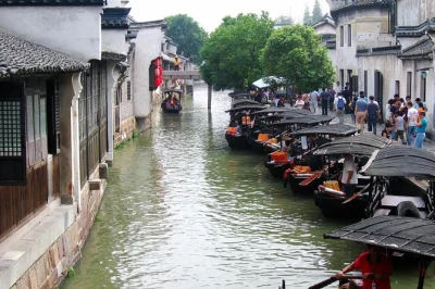 Step off shanghai’s busy streets into zhujiajiao’s quiet canals, stroll old markets, and float past ming bridges. includes hotel pickup, boat ride, and guide.