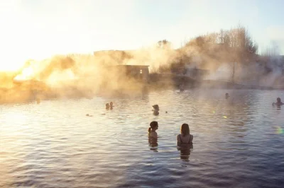 Sink into iceland’s secret lagoon near fludir, feel the geothermal steam, and watch mini-geysers erupt as you soak—entry ticket with easy access included.