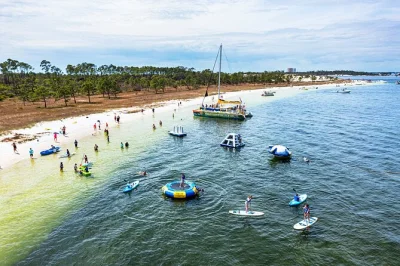 Sail from panama city beach to shell island by catamaran, try kayaking and paddle boarding, splash on the inflatable water park, and spot dolphins—includes all activities.