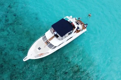 Set out from puerto aventuras on a private yacht for snorkeling, beach time, fresh guacamole, open bar, and warm crew hospitality. includes gear and lunch.