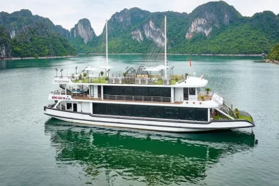 Sail ha long bay on a luxury cruise with buffet lunch, kayaking at luon cave, and a visit to titop island. includes english-speaking guide and pickup from hanoi.