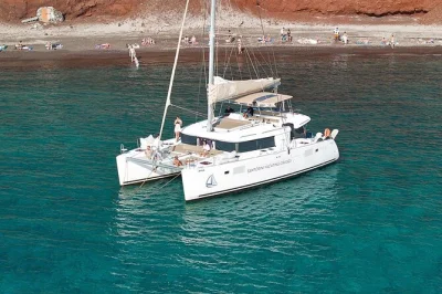 Feel the sea breeze on a santorini catamaran cruise, swim at red beach, soak in volcanic hot springs, and enjoy greek lunch onboard. includes transfers & drinks.