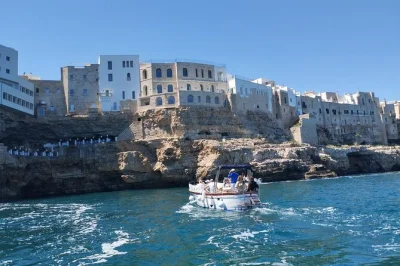 Feel the sea breeze on a shared gozzo boat tour from monopoli to polignano caves, with swimming stops, local snacks, prosecco, and a friendly guide—includes drinks.