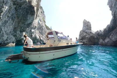 Sail capri’s coast in a small group, swim by faraglioni rocks, explore grottos, and sip limoncello on board. meet at marina grande—drinks and snacks included.