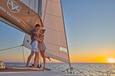 Feel the aegean breeze on a santorini catamaran cruise with bbq lunch, open bar, and swimming at red beach, white beach, and thirasia. includes pickup.