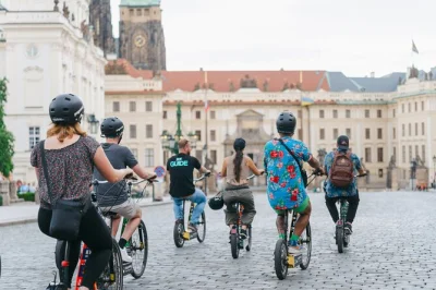 Start by charles bridge, ride e-scooters past prague castle, lennon wall & letná park with a local guide. small group tour includes helmet, training, and audio guides.