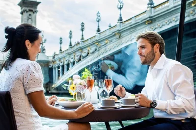 Float past paris icons like the eiffel tower and notre-dame on a glass-enclosed seine lunch cruise with gourmet french courses, wine, and private table seating.
