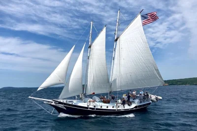 Sail grand traverse bay from traverse city on a 63-ft schooner, sample local food, wine & cocktails, help raise the sails—includes crew, drinks & lunch.