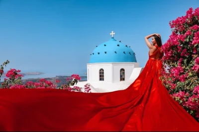 Step into a flying dress for a photoshoot in santorini’s imerovigli, with private pickup, pro photographer, and iconic blue domes. includes all photos & styling.