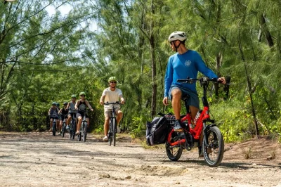 Pedal quiet trails past mangroves, hell’s rocks, and governor’s beach on a grand cayman e-bike tour with a naturalist guide—includes helmet and easy electric bikes.