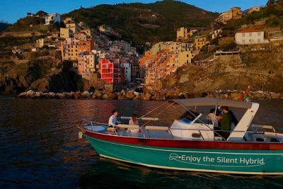 Watch the sun melt over cinque terre’s villages on a small-group boat cruise from monterosso, with local aperitif, english-speaking guide, and pickup included.