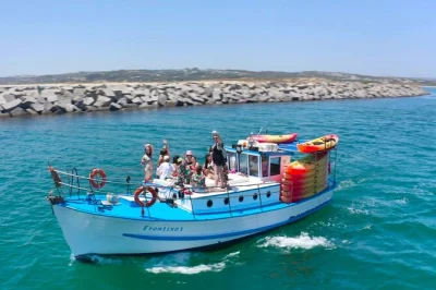Feel the wild algarve coast from alvor to praia do vau by boat and kayak, with secret caves, swimming, local stories, snacks, and all gear included.