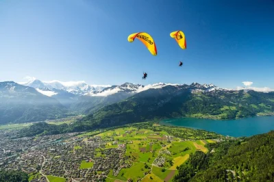 Feel the rush of tandem paragliding above interlaken, soar over lake thun & the swiss alps, includes transport to beatenberg & all gear, small group guided flight.