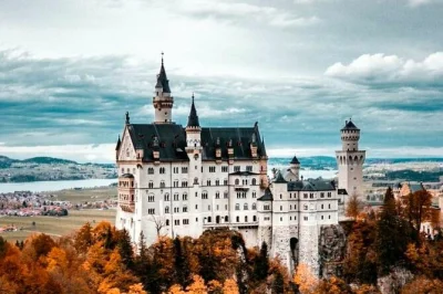 Feel the magic of neuschwanstein castle with skip-the-line entry, a stroll to marienbrücke, and a horse carriage ride back to hohenschwangau. includes pickup.