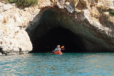 Glide from kalantos beach to rina cave on a guided sea kayak tour in naxos, with snorkeling, cliff jumps, and a homemade picnic lunch included.