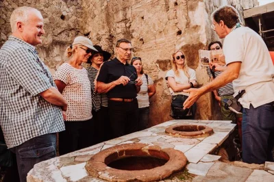 Step inside pompeii and herculaneum with an archaeologist, explore ancient streets and houses, see plaster casts, entry tickets and train ride included.