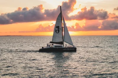 Let the caribbean breeze and golden sunset set the mood on a lady grace catamaran sail from ritz-carlton, with open bar, gourmet snacks, and easy boarding.