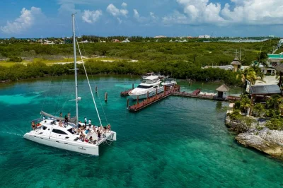 Feel the breeze on a cancun to isla mujeres catamaran, snorkel el meco reef, enjoy playa norte, and savor a beach club buffet. includes pickup and open bar.