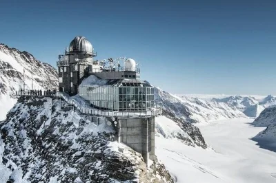 Ride the eiger express & cogwheel train from zurich to jungfraujoch, explore the ice palace, and take in panoramic views at the sphinx observatory. includes guide & transport.
