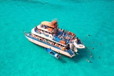Feel the sea breeze on a three-level boat to isla mujeres, snorkel el meco reef, splash down slides, enjoy lunch & drinks, with free time at north beach.