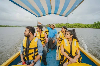 Feel the spirit of divar island in goa with sunset river cruise, temple ruins, feni tasting at a local tavern, and guided stories. includes snacks and all fees.