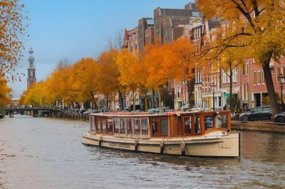 Float past amsterdam icons like the rijksmuseum and skinny bridge on a luxury electric canal cruise with unlimited drinks, local guide, and flexible covered boats.
