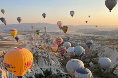 Float above cappadocia’s valleys at sunrise, watch 150 balloons rise, and get close to fairy chimneys. includes pickup, snacks, and expert pilots.
