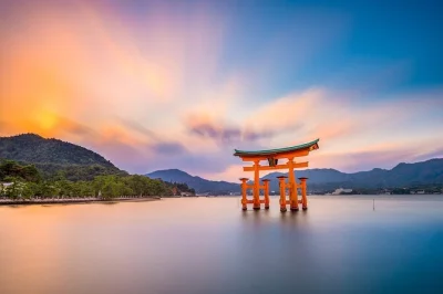 Feel the spirit of miyajima island with a private guide, explore itsukushima shrine, meet friendly deer, and enjoy local snacks. includes flexible pickup.