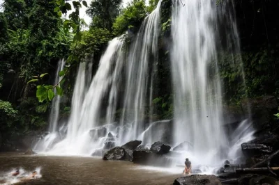 Feel ancient cambodia at phnom kulen—swim beneath waterfalls, see riverbed carvings, and share a picnic lunch. includes siem reap pickup and local guide.