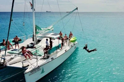 Feel the breeze on a st maarten catamaran day sail—homemade lunch, open bar, snorkeling stops, and the tarzan swing. includes pickup near cruise port.