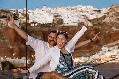 Feel the aegean breeze on a santorini catamaran cruise with swimming stops at volcanic springs, a greek bbq meal, open bar, and hotel pickup included.