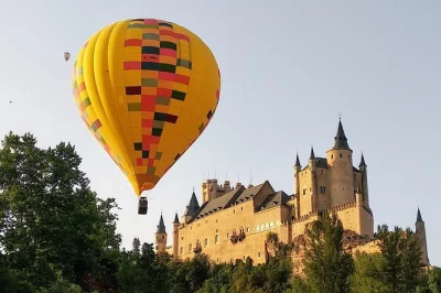 Float above segovia’s medieval skyline at sunrise, spot the aqueduct & alcázar from the air, then toast your flight with a picnic & cava. includes photos & pickup.