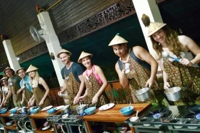 Get hands-on in chiang mai with a thai cooking class, stroll a local market, pick herbs in an organic garden, and enjoy your own dishes. includes hotel pickup.