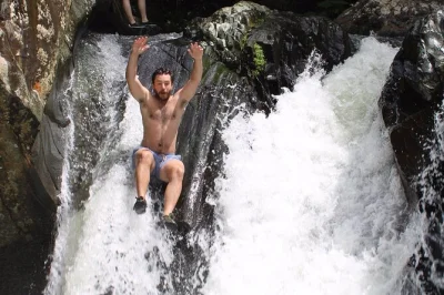 Feel the rush on el yunque’s natural waterslides, hike with a local guide, and enjoy small group adventure with pickup from san juan. includes all fees & safety gear.