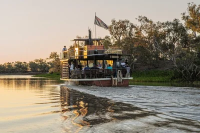 Feel the outback come alive on a longreach sunset cruise along the thomson river, with campfire dinner, bush poetry, and an open-air movie under the stars. includes local transfers.