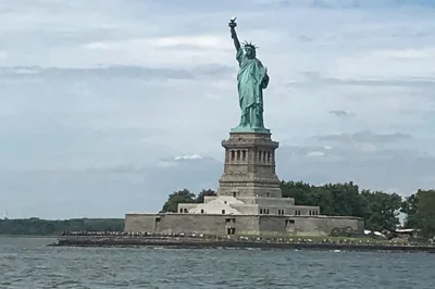 See the statue of liberty from the ferry, walk brooklyn bridge, visit 9/11 memorial & grand central on a guided nyc bus tour with skip-the-line ferry ride.