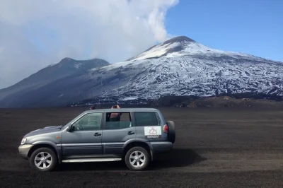 Feel the crunch of old lava underfoot on a mt etna 4x4 tour from trecastagni, explore volcanic caves with a guide, and end with sicilian food tasting. includes pickup.