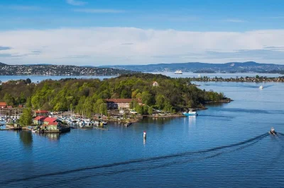 Feel the oslofjord breeze as you island-hop by ferry, wander forest trails, explore a 900-year-old abbey, and share hot drinks on quiet beaches—guided tour with tickets included.