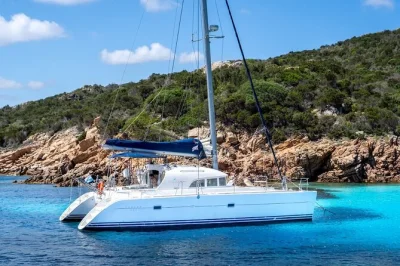 Step onto a catamaran from cannigione to maddalena’s turquoise bays, swim and snorkel, taste local wine and sardinian seafood lunch, with all drinks included.