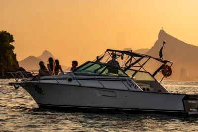 Feel the rio sunset on a boat tour across guanabara bay, with drinks, snacks, music, and swim stops at adão e eva beach. includes english-speaking guide.