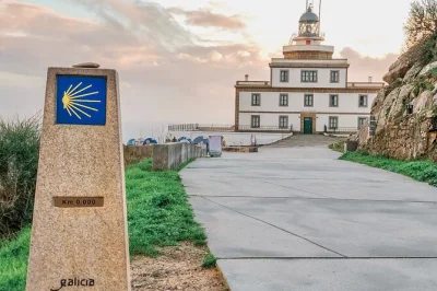 Follow the wild galician coast to finisterre, muxía, and ezaro waterfall with a local guide, coach transport, and lunch stop in a fishing village included.