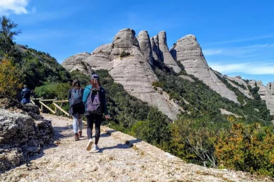 Feel the cool mountain air on a montserrat hiking tour from barcelona, explore the monastery before crowds, and sample catalan snacks. includes skip-the-line entry.