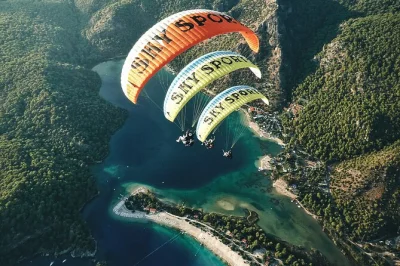 Feel the rush above oludeniz and fethiye on a tandem paragliding flight, guided by certified pilots. includes hotel pickup, all equipment, and gentle beach landing.