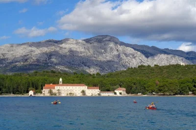 Kayak from korčula to vrnik & badija islands, explore old stone quarries, meet calm deer, and taste homemade grk wine with pastries. small group tour includes all gear.