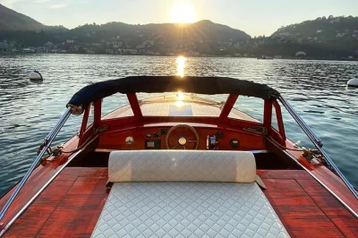 Feel the warmth of a classic wooden boat on lake como, with heated cabin, local captain, and prosecco. includes private group tour, drinks, and flexible itinerary.