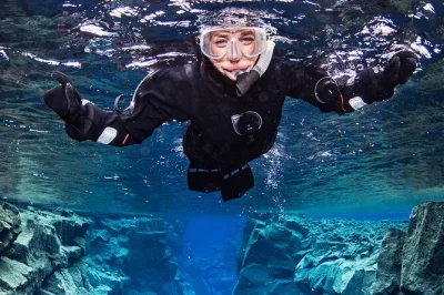 Float between continents at silfra in thingvellir, snorkeling with a local guide in crystal-clear water. includes dry suit, hot chocolate, and all gear.