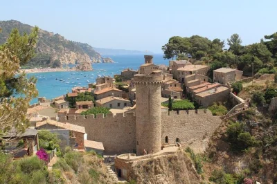 Feel the real costa brava on a day trip from barcelona with boat ride, guided walk in tossa de mar, and time to wander seaside villages. includes coach transport.