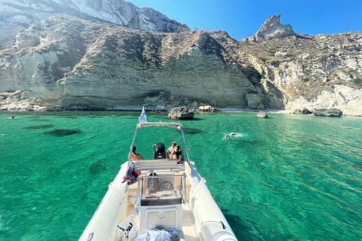 Feel the sea breeze near cagliari’s devil’s saddle with swim stops, snorkeling gear, and a glass of prosecco. small group boat tour with city center departure.