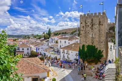 Feel the spirit of fátima, taste seafood in nazaré, and sip cherry liqueur in Óbidos on a small group day trip from lisbon. includes pickup & local guide.