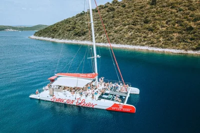Feel the adriatic breeze on a full-day catamaran cruise from split to hvar and pakleni islands, with swim stops, local food, open bar, and guided hvar tour included.